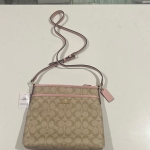 Never used crossbody Coach bag in light pink.